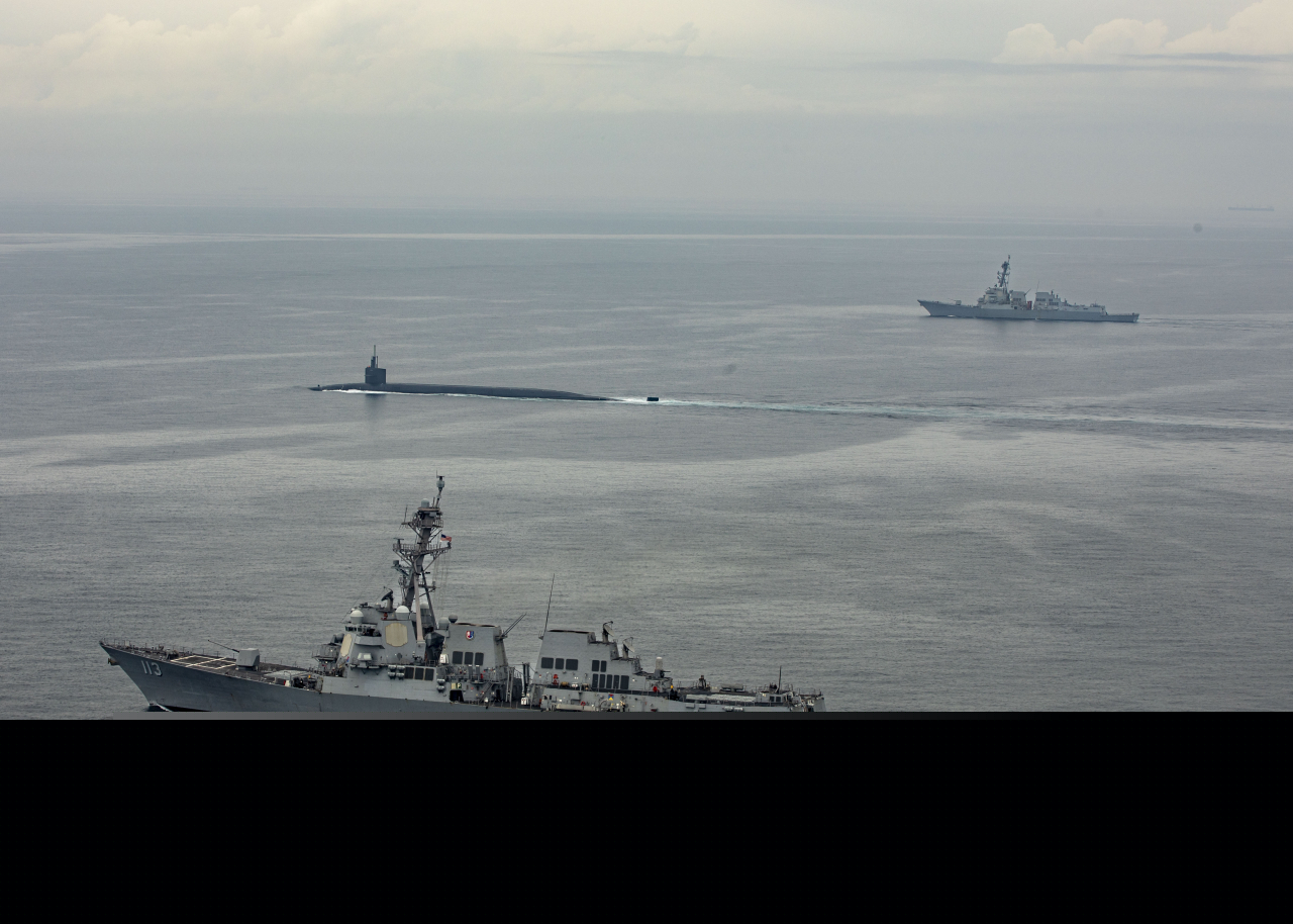 The Ohio-class ballistic-missile submarine USS Kentucky (SSBN 737) proceeds on the surface to Busan for a port visit while escorted by Arleigh Burke-class guided-missile destroyers USS John Finn (DDG 113) and USS Ralph Johnson (DDG 114), July 18, 2023. (US Navy)