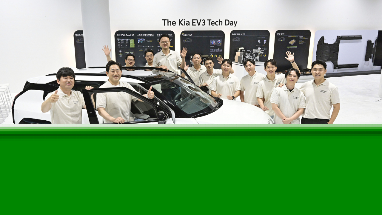Kia engineers pose for a photo with the Kia EV3 at a studio in Seoul on Tuesday. (Hyundai Motor Group)