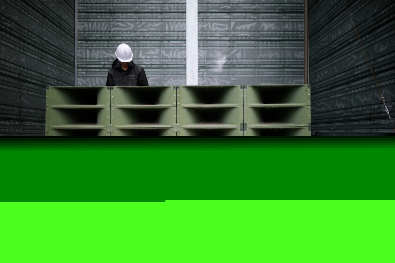 A worker dismantles loudspeakers set up for propaganda broadcasts near the demilitarized zone in Paju, South Korea, on May 1, 2018. (AP-Yonhap)