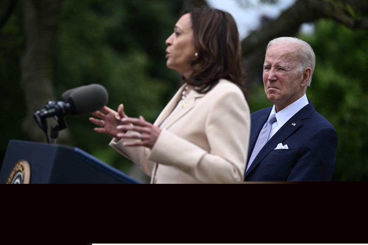 US President Joe Biden looks on as US Vice President Kamala Harris delivers remarks during National Small Business Week in the Rose Garden of the White House in Washington, DC, on May 1, 2023. (AP)