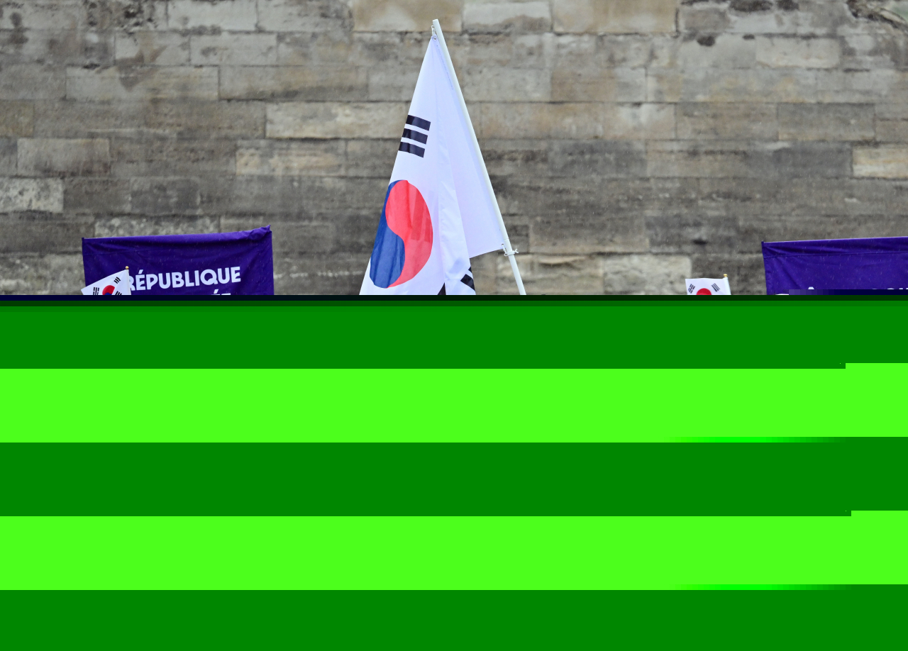 The South Korean delegation of athletes including flag bearers -- high jumper Woo Sang-hyeok (third from right, front) and swimmer Kim Seo-yeong (fourth from right, front) -- is seen on a boat sailing along the Seine River during the opening ceremony of the Paris 2024 Olympic Games on Friday. (Yonhap)